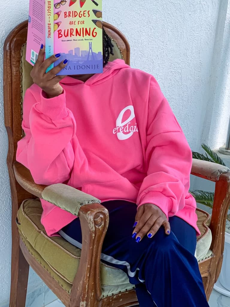 Casually reading while in the Strawberry pink hoodie